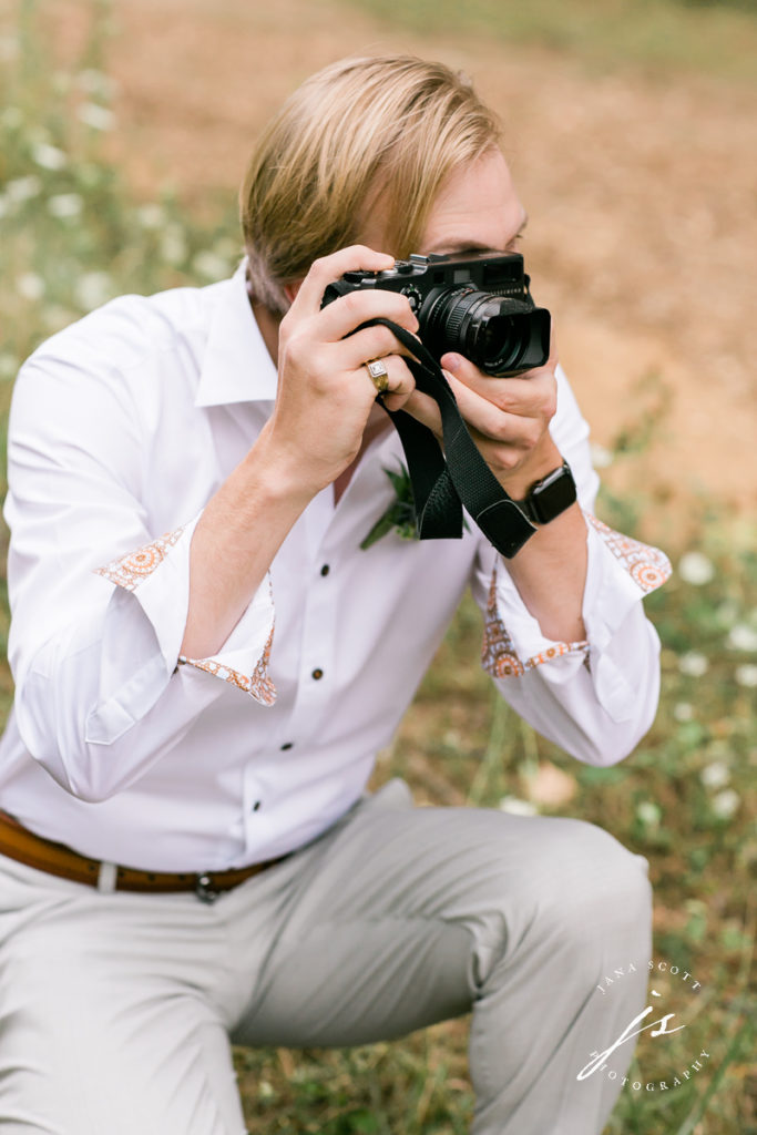 groom with a film camera