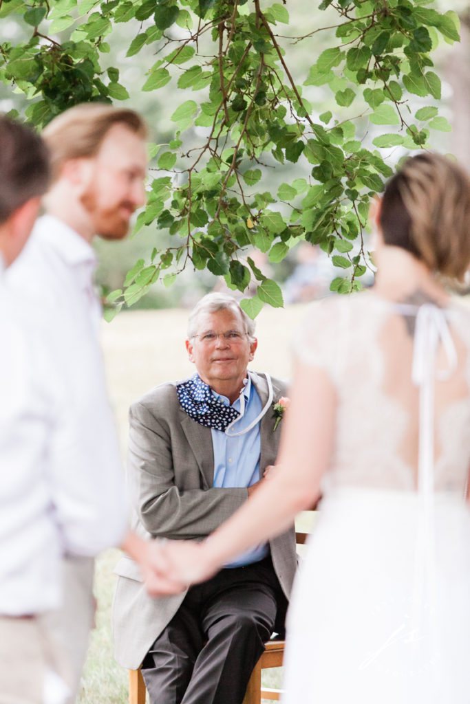 grooms father looking at bride and groom during the ceremony