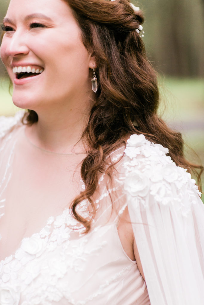 close up of bride's smile, earrings and gown