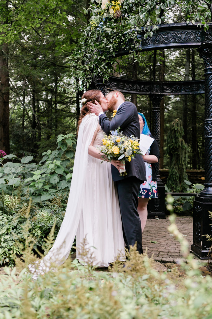 bride and groom kissing at the end of wedding ceremony