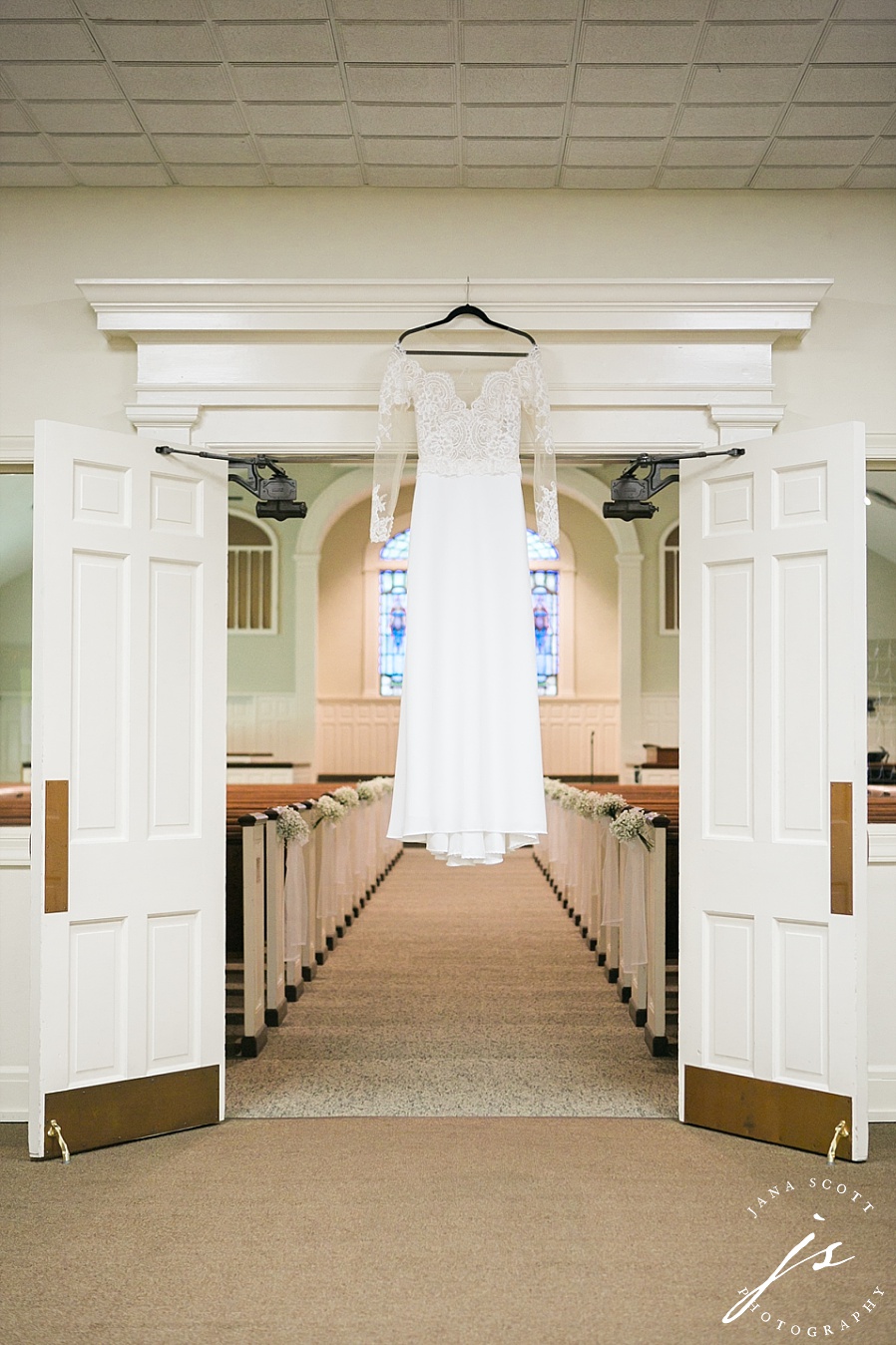 brides dress hanging in church