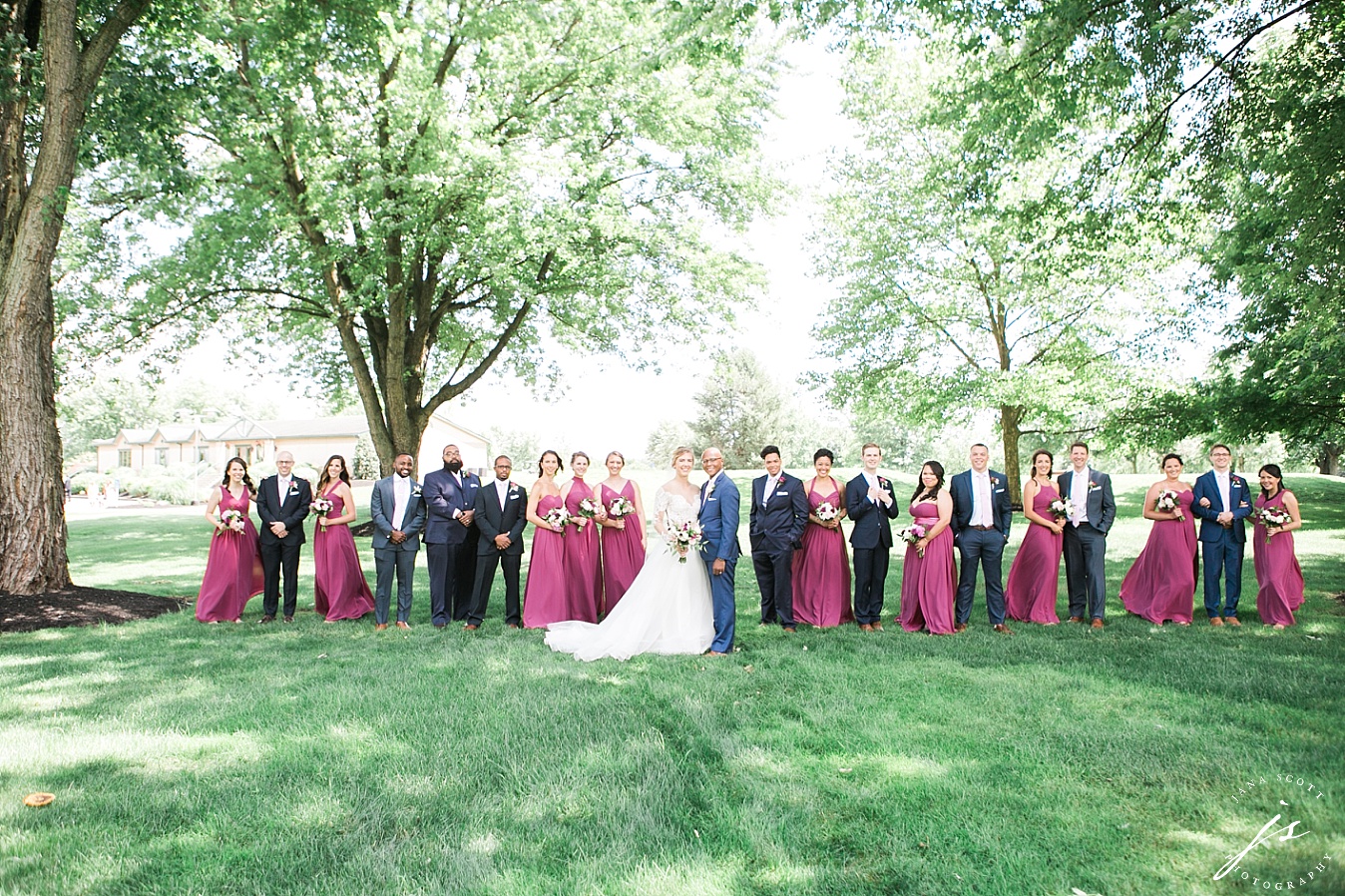 entire bridal party on the wedding reception lawn