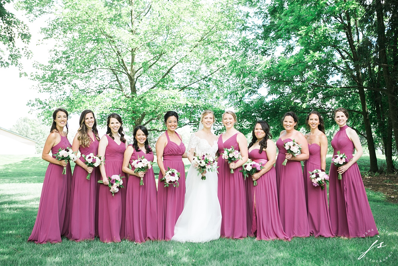 bride and her bridesmaids on the lawn