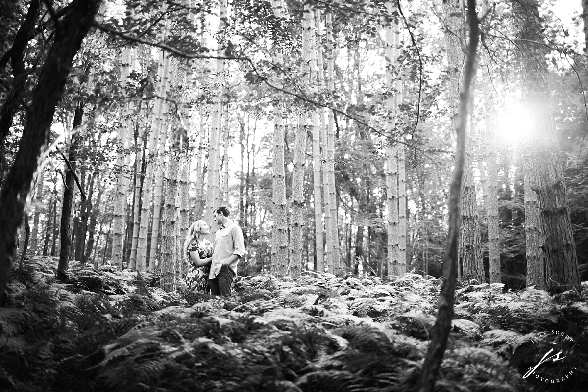 black and white engagement photos in the woods