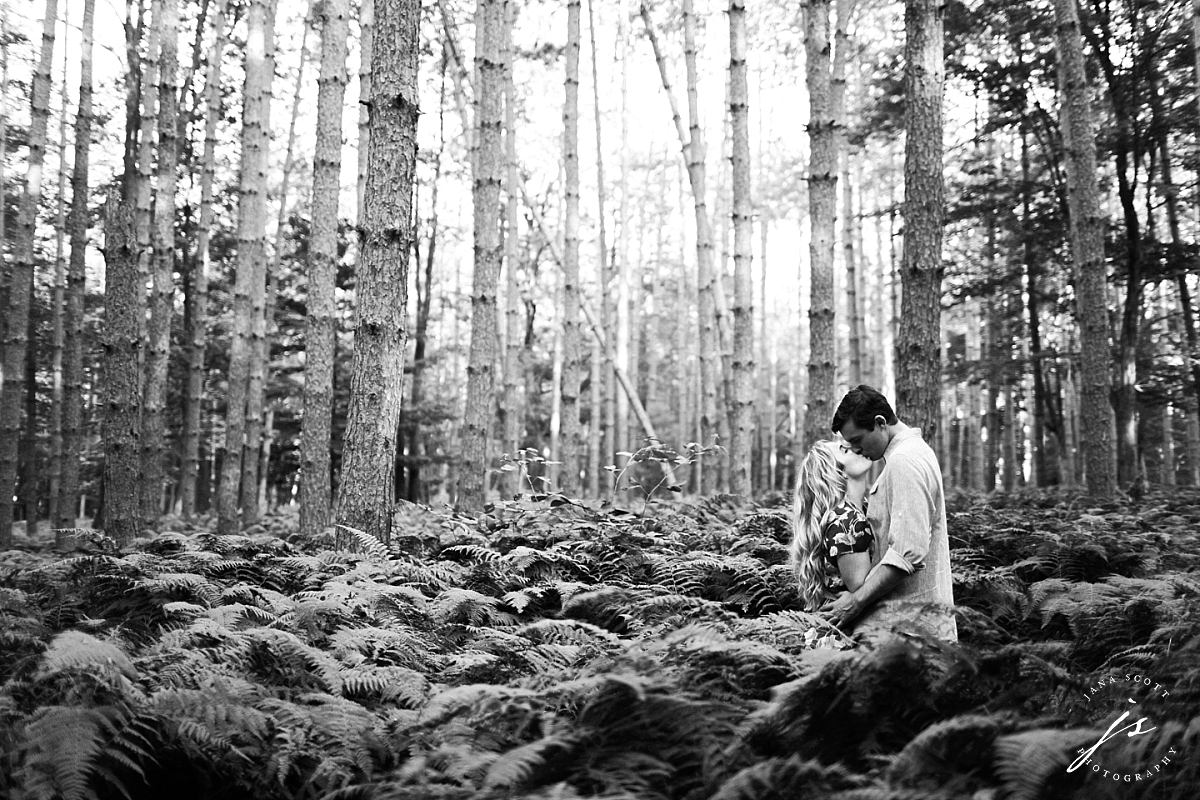 black and white photo of couple in the woods