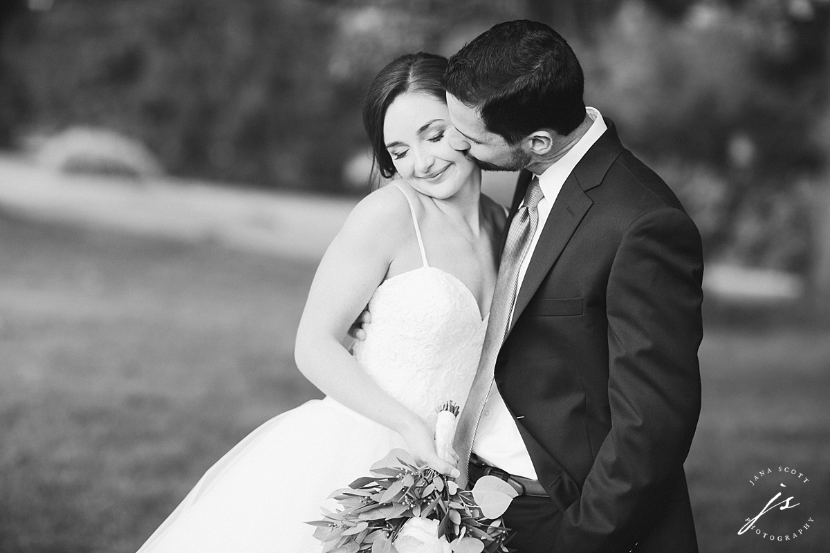 Groom kisses bride at centre hills country club