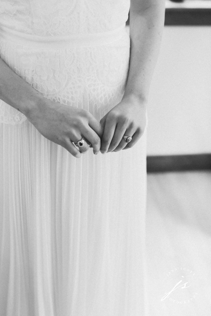 brides hands while getting dressed