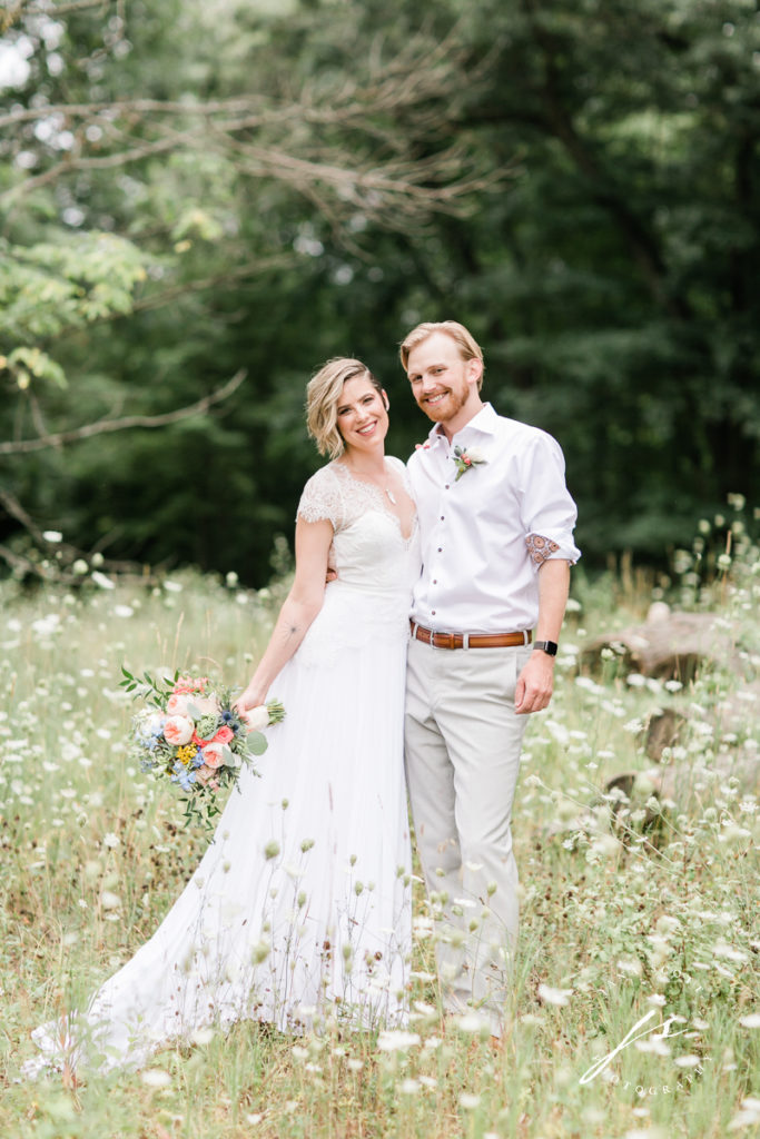 bride and groom in a field of queen annes lace