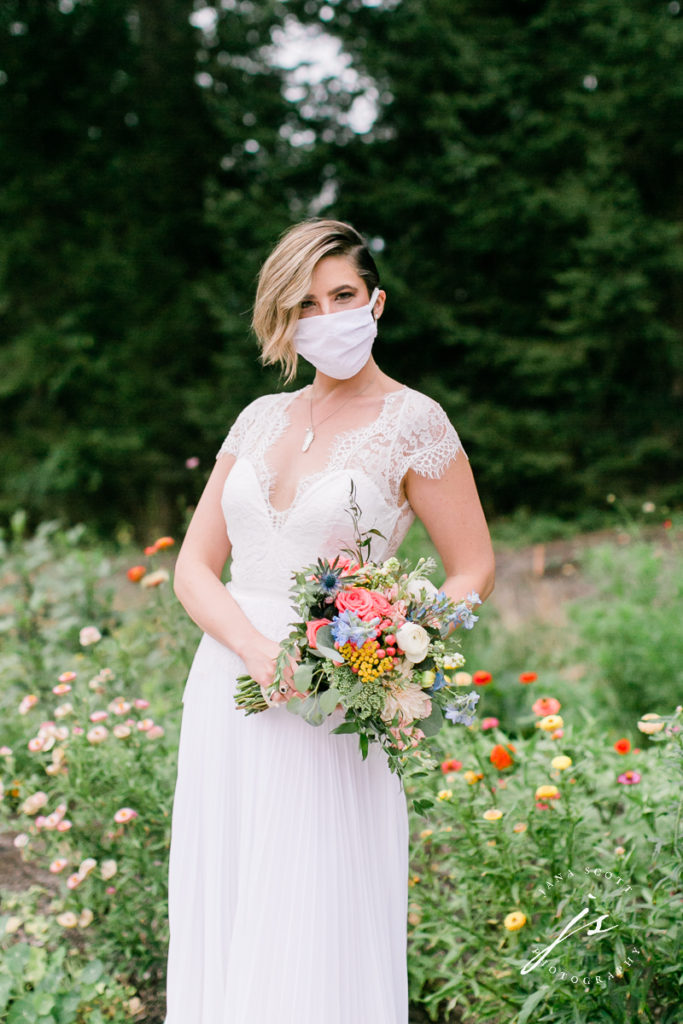 bride wearing mask and holding boquet