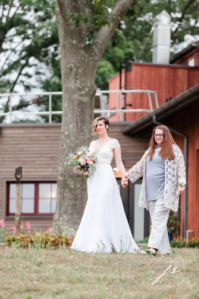 bride walking to the altar with her mom
