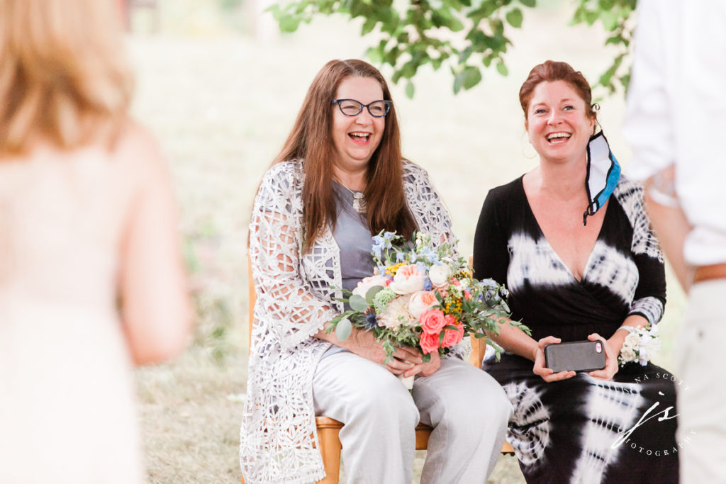 mother of the bride laughing during ceremony